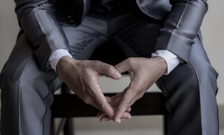 Close-up of hands in a classic business suit, conveying elegance and professionalism.