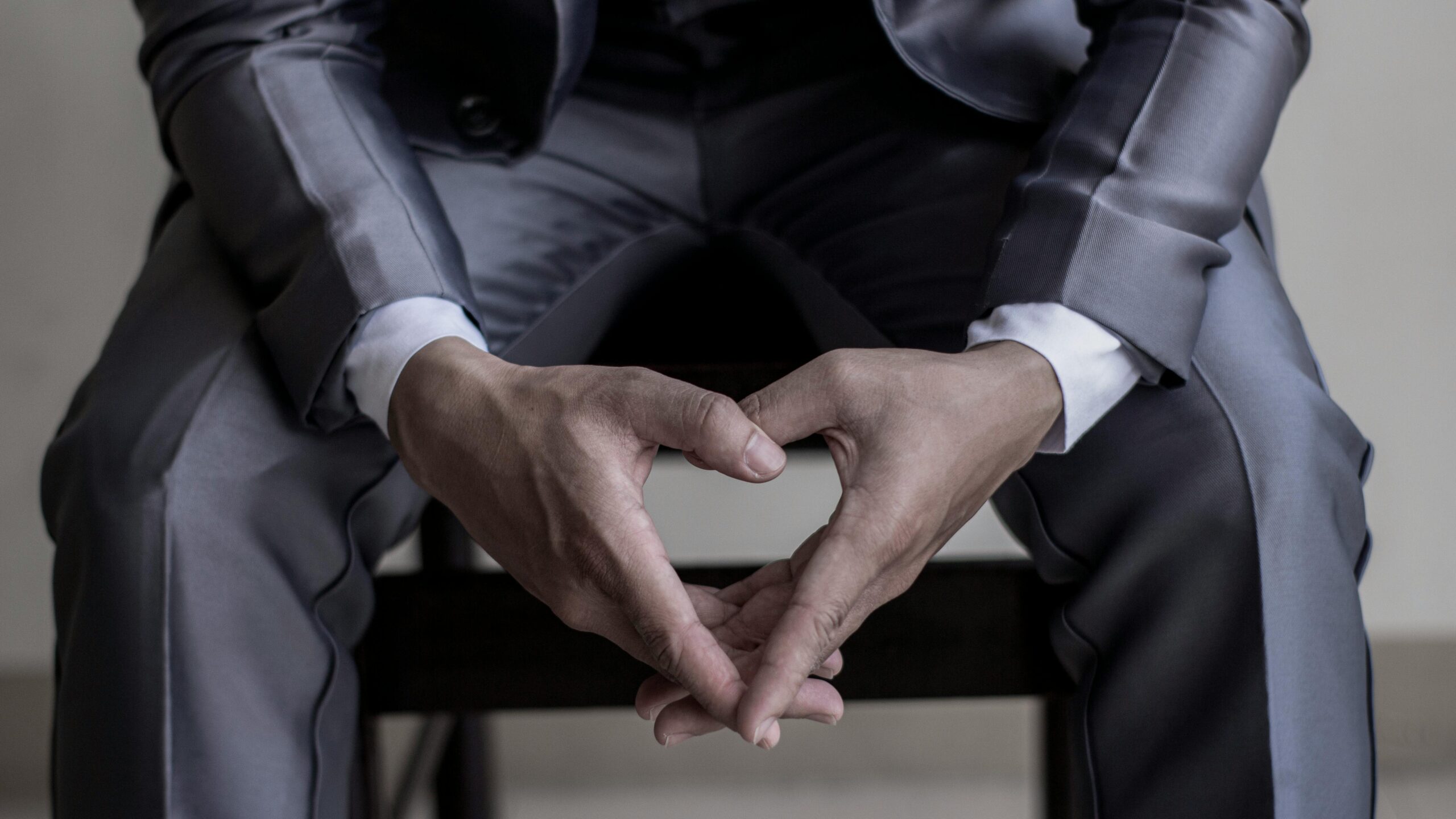 Close-up of hands in a classic business suit, conveying elegance and professionalism.