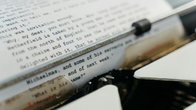 A vintage typewriter actively typing manuscript pages, evoking a sense of timeless creation.